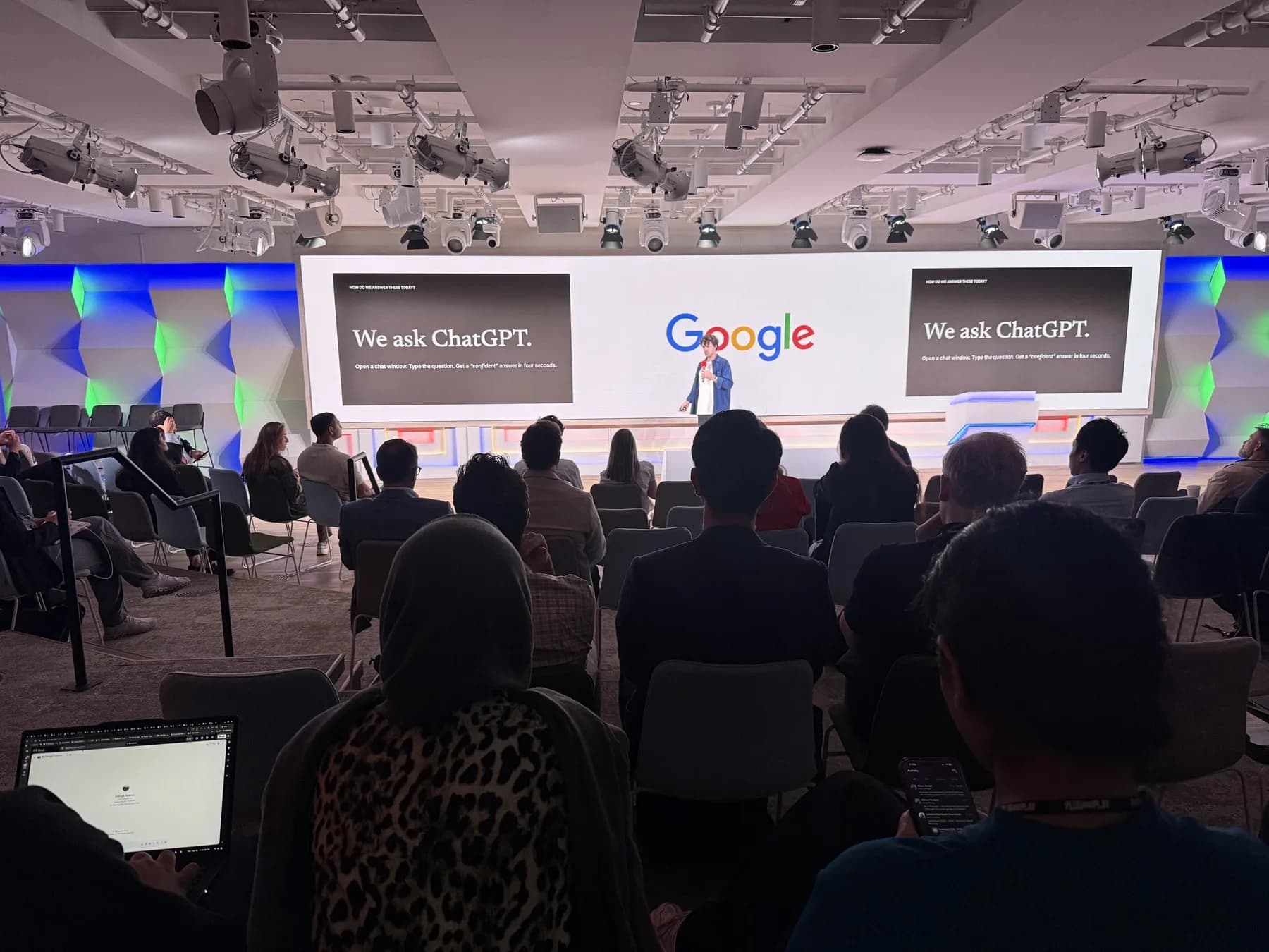 Liam Bolling presenting a slide that reads We ask ChatGPT on the Google stage