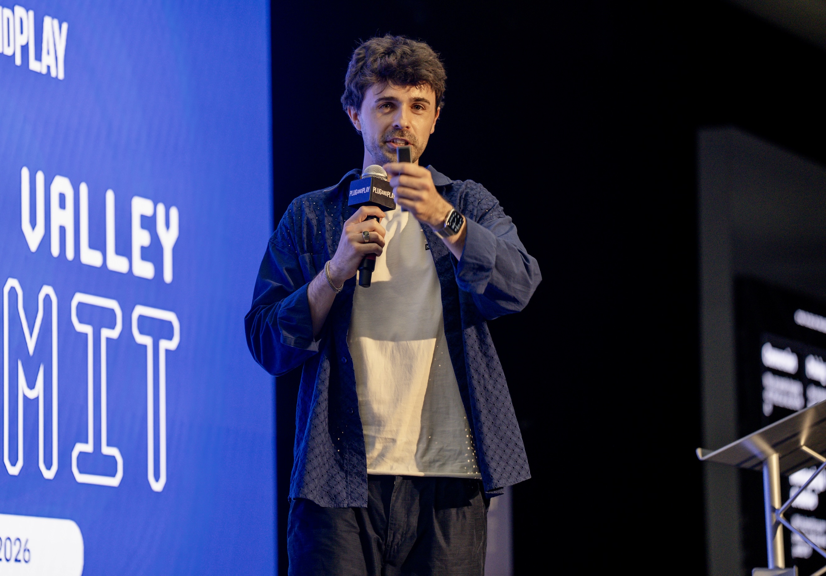 Liam Bolling presenting Rehearsals on stage at Plug and Play